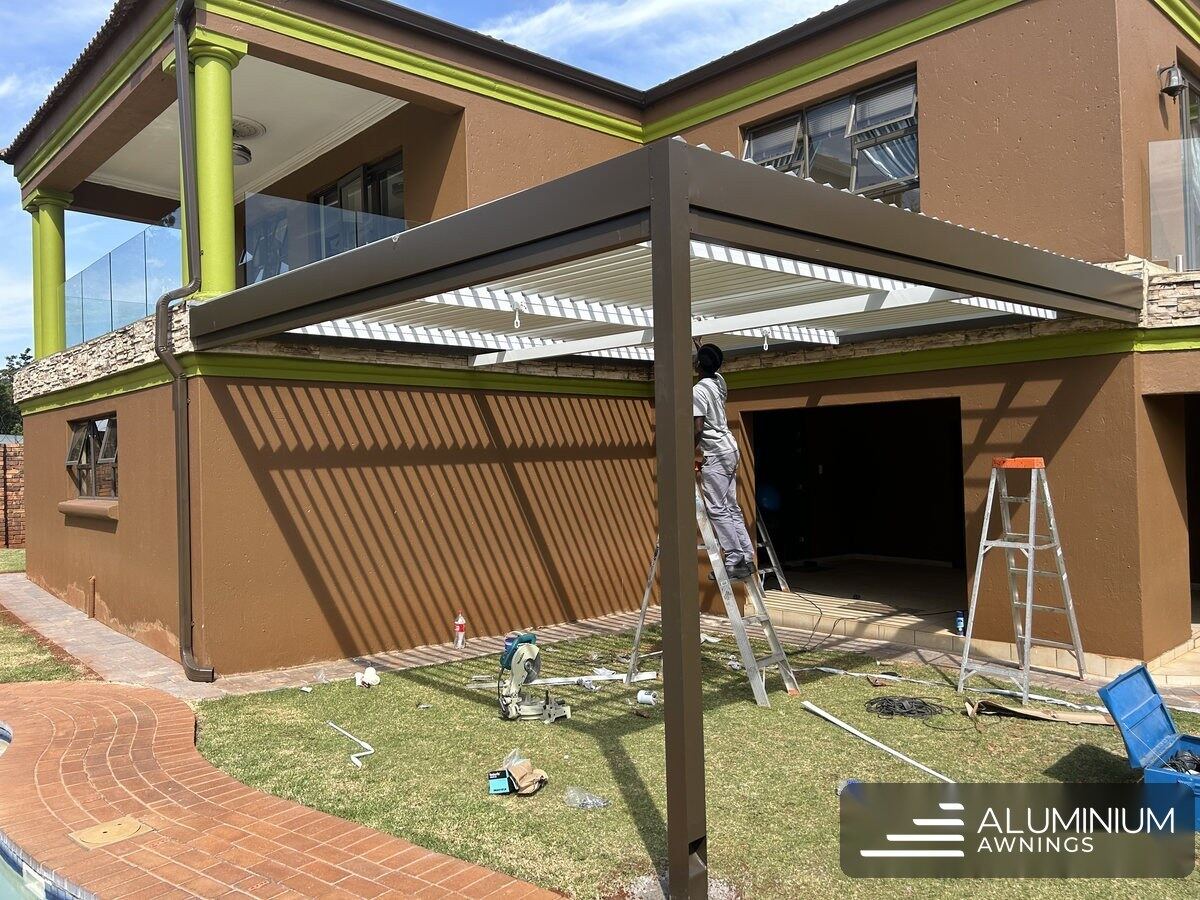 Bronze louvre roof at the Hermanus home seen from the garden during fitting.