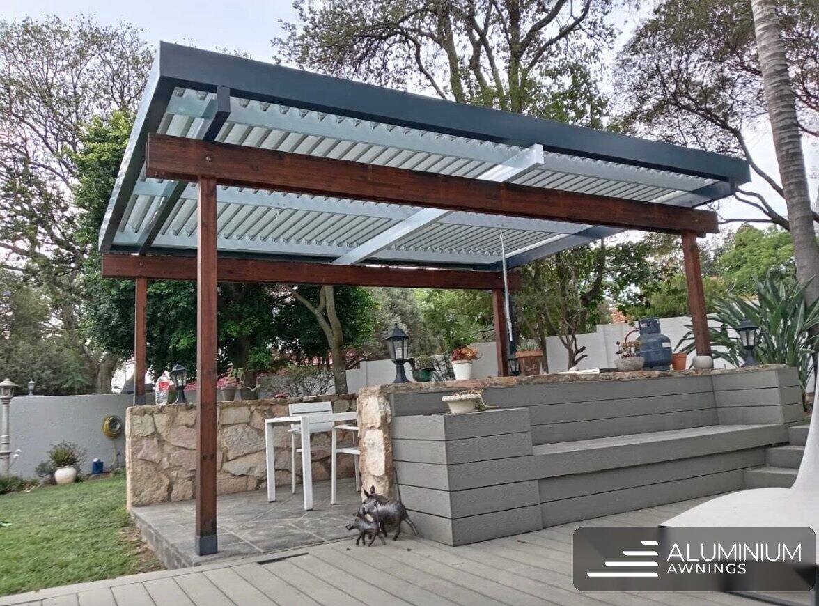 Motorised louvre awning in charcoal frame with white louvre blades — Sunset Beach, Cape Town West Coast